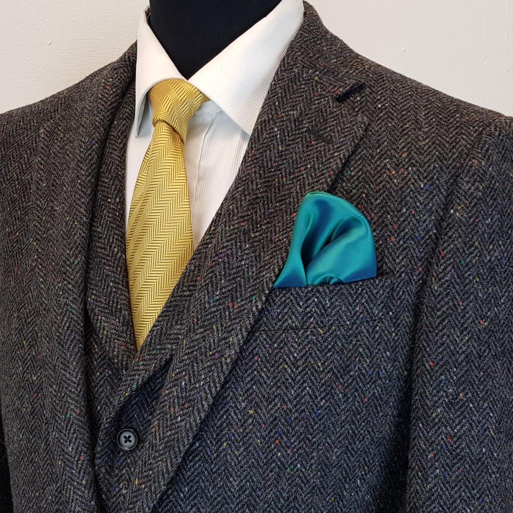 Input image for: Extract the yellow necktie worn in the image.