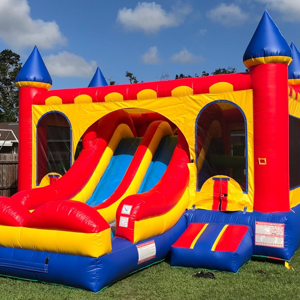 Input image for: Remove the colorful inflatable bounce house in the foreground.