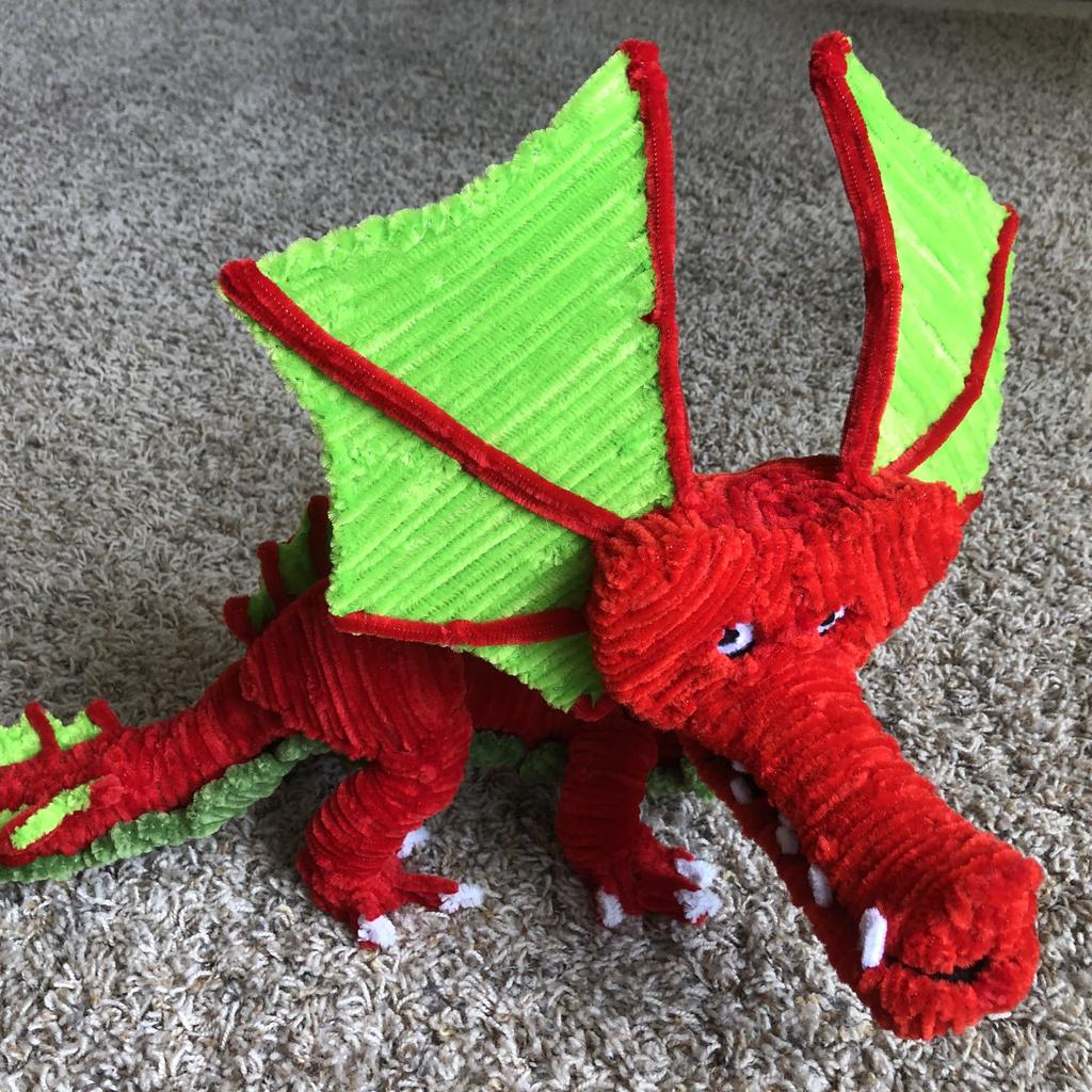 Input image for: Replace the pipe-cleaner dragon with a bright yellow rubber duck.